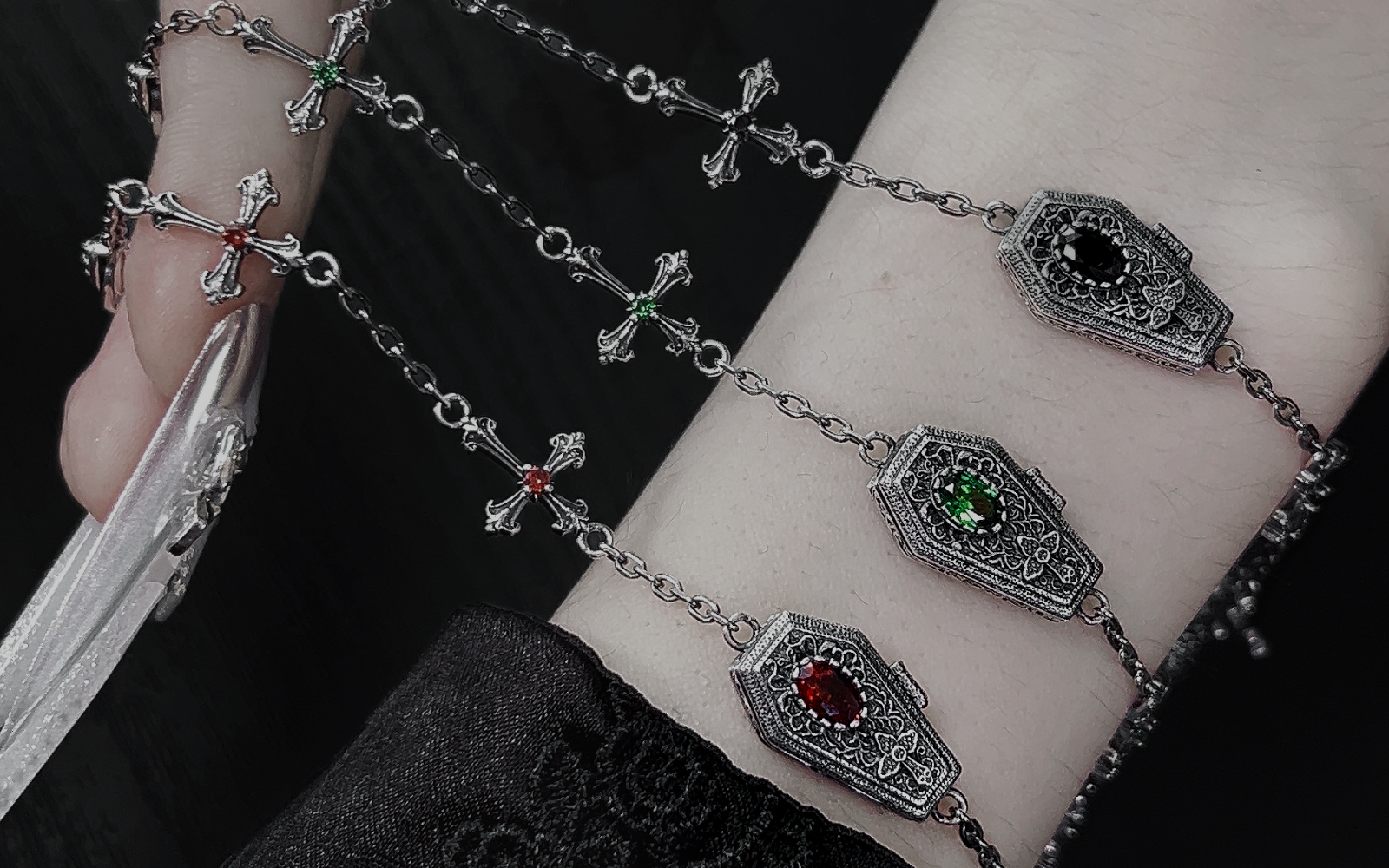 Gothic silver jewelry arranged on black velvet